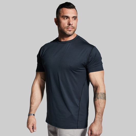 Man wearing a black athletic t-shirt against a gray background