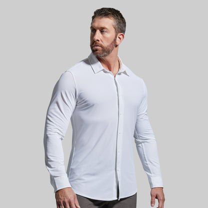 Man wearing a white dress shirt against a gray background