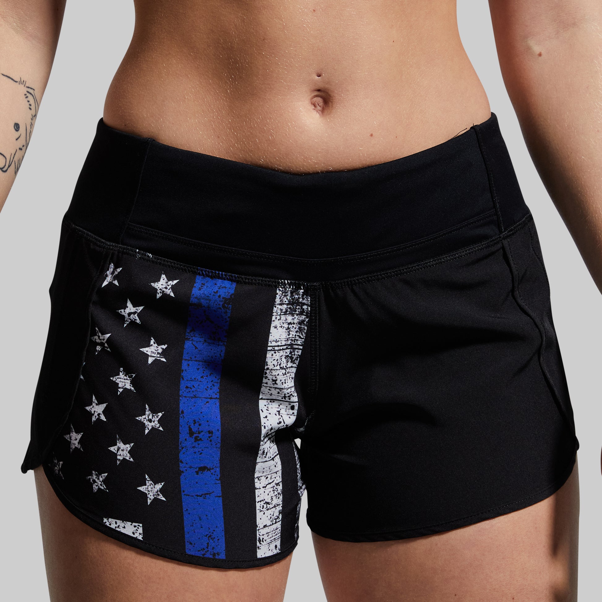 Black shorts with American flag design featuring a blue stripe on a neutral background