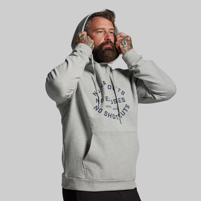 Man wearing a gray hoodie with text on a plain background