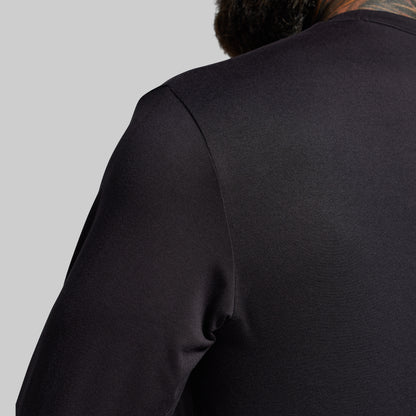 Black long-sleeve shirt on a gray background