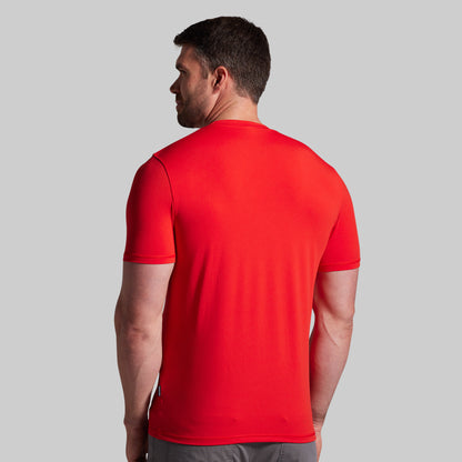 Man wearing a red t-shirt on a gray background