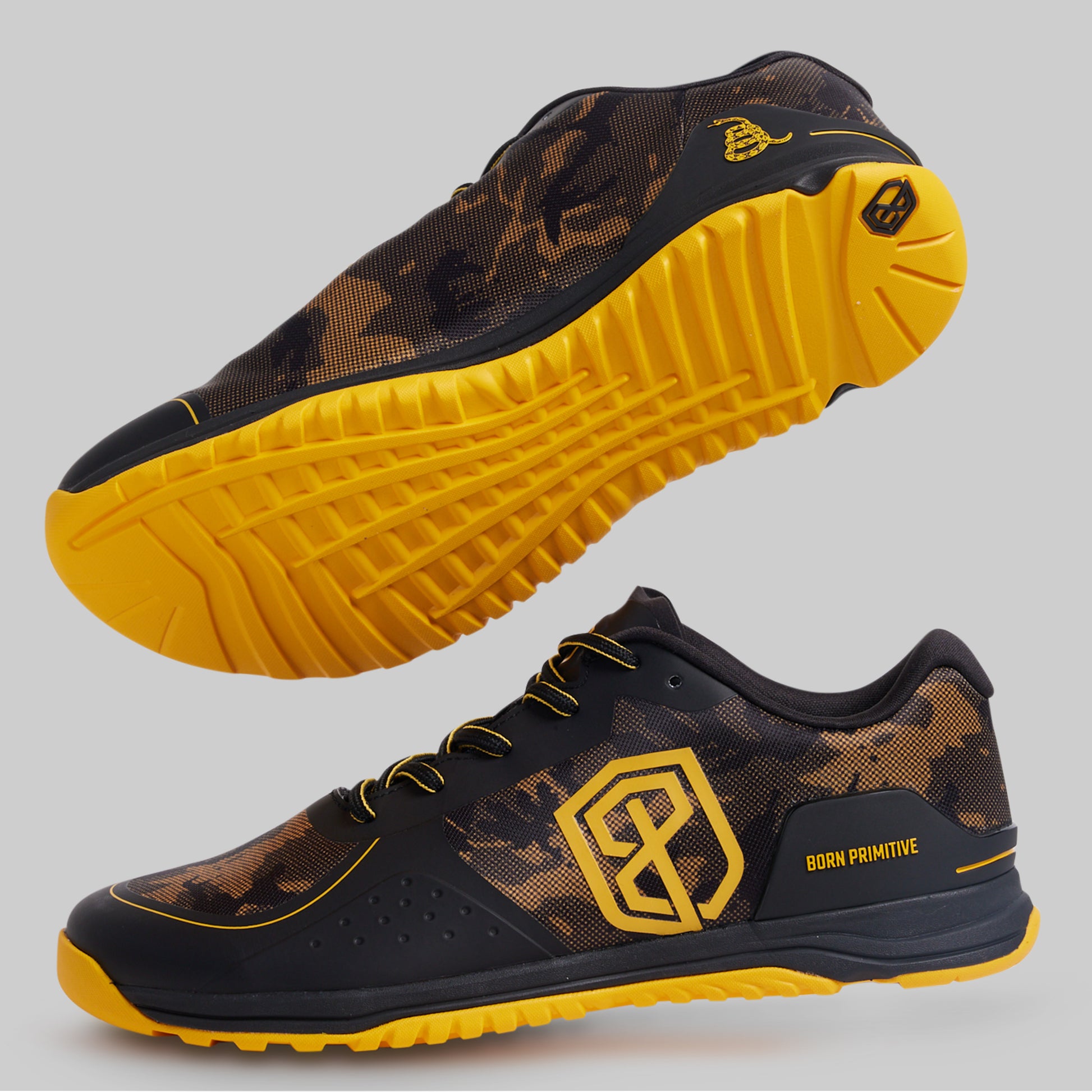 Black and yellow athletic shoes with a prominent brand logo on a gray background