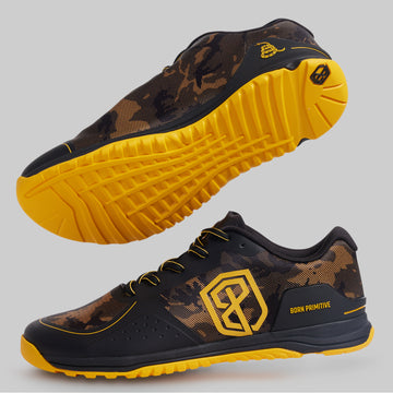 Black and yellow athletic shoes with a prominent brand logo on a gray background