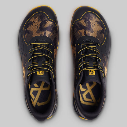 Black and gold sneakers with unique patterns on a light gray background