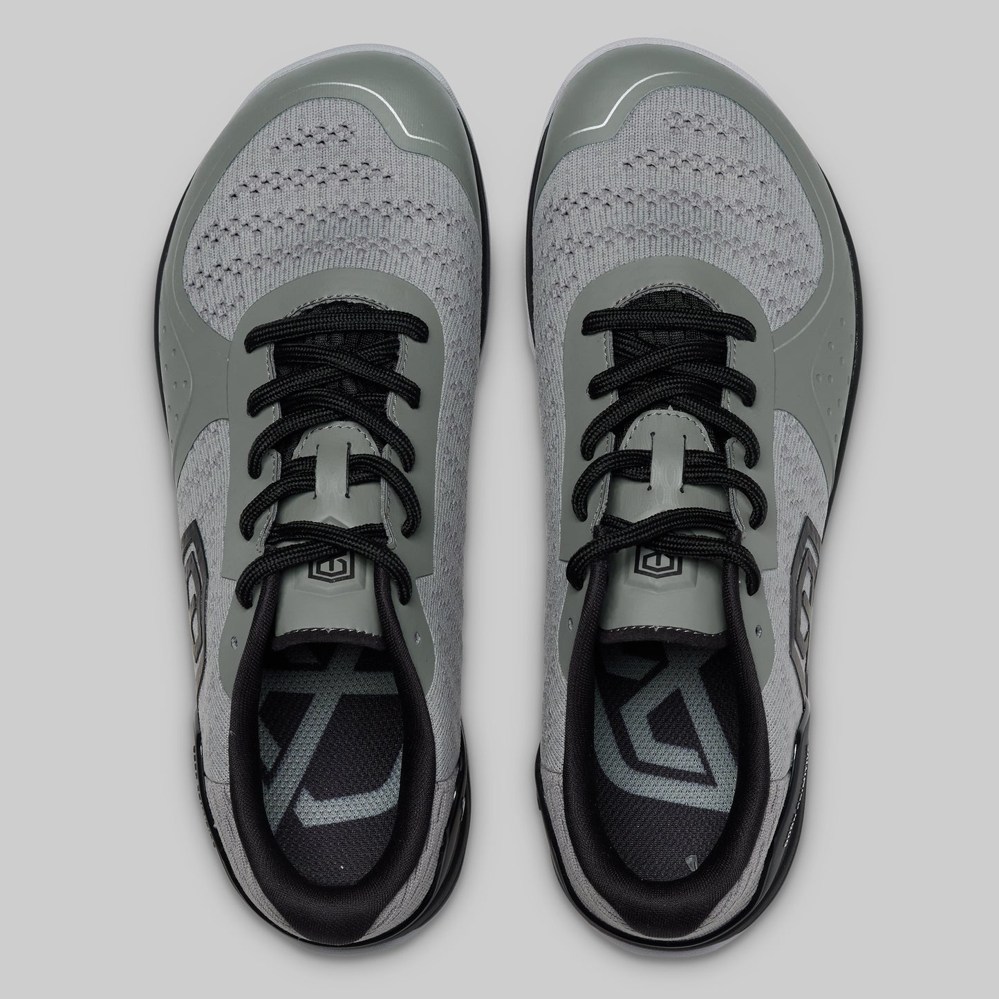 Pair of gray and black athletic shoes on a light gray background