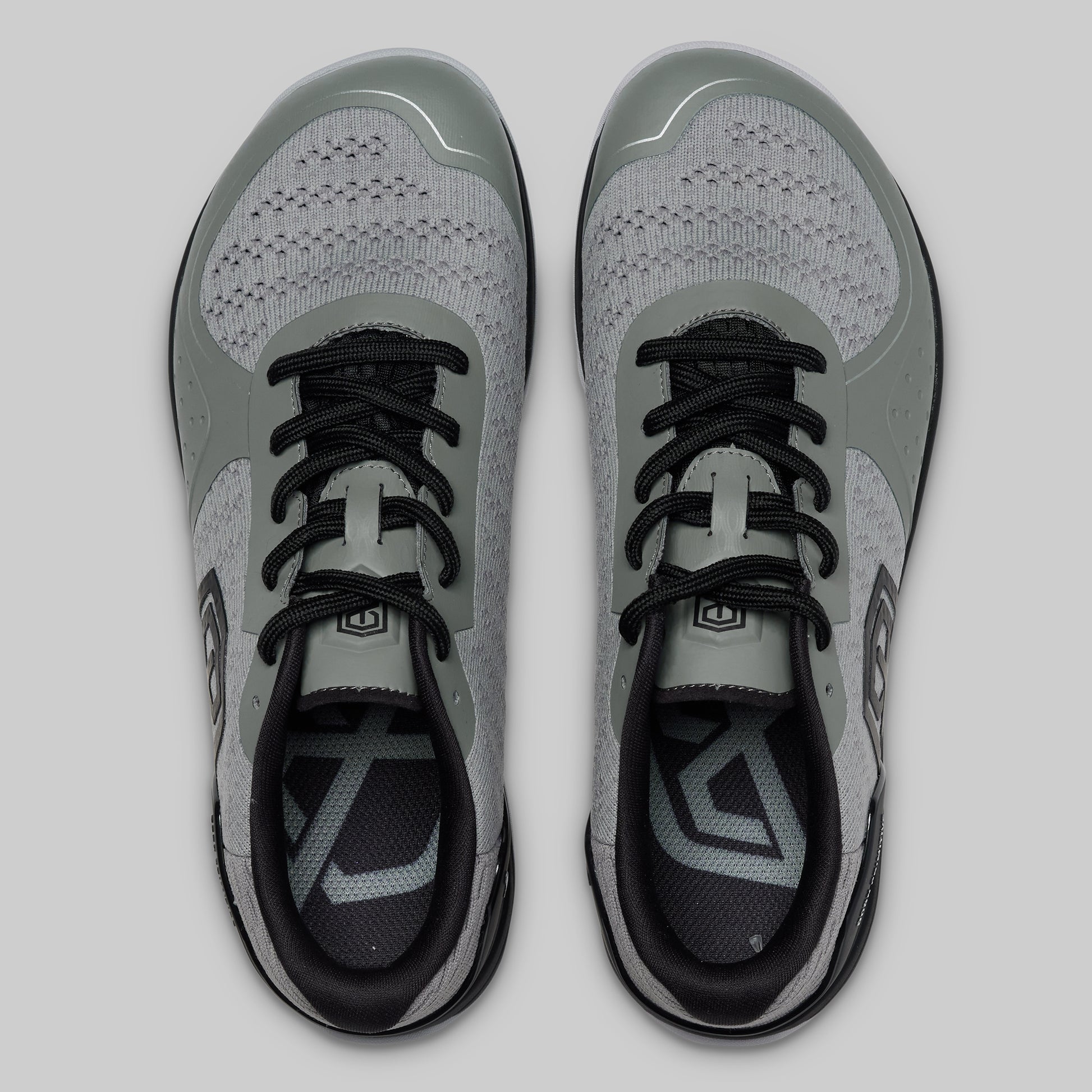 Pair of gray and black athletic shoes on a light gray background