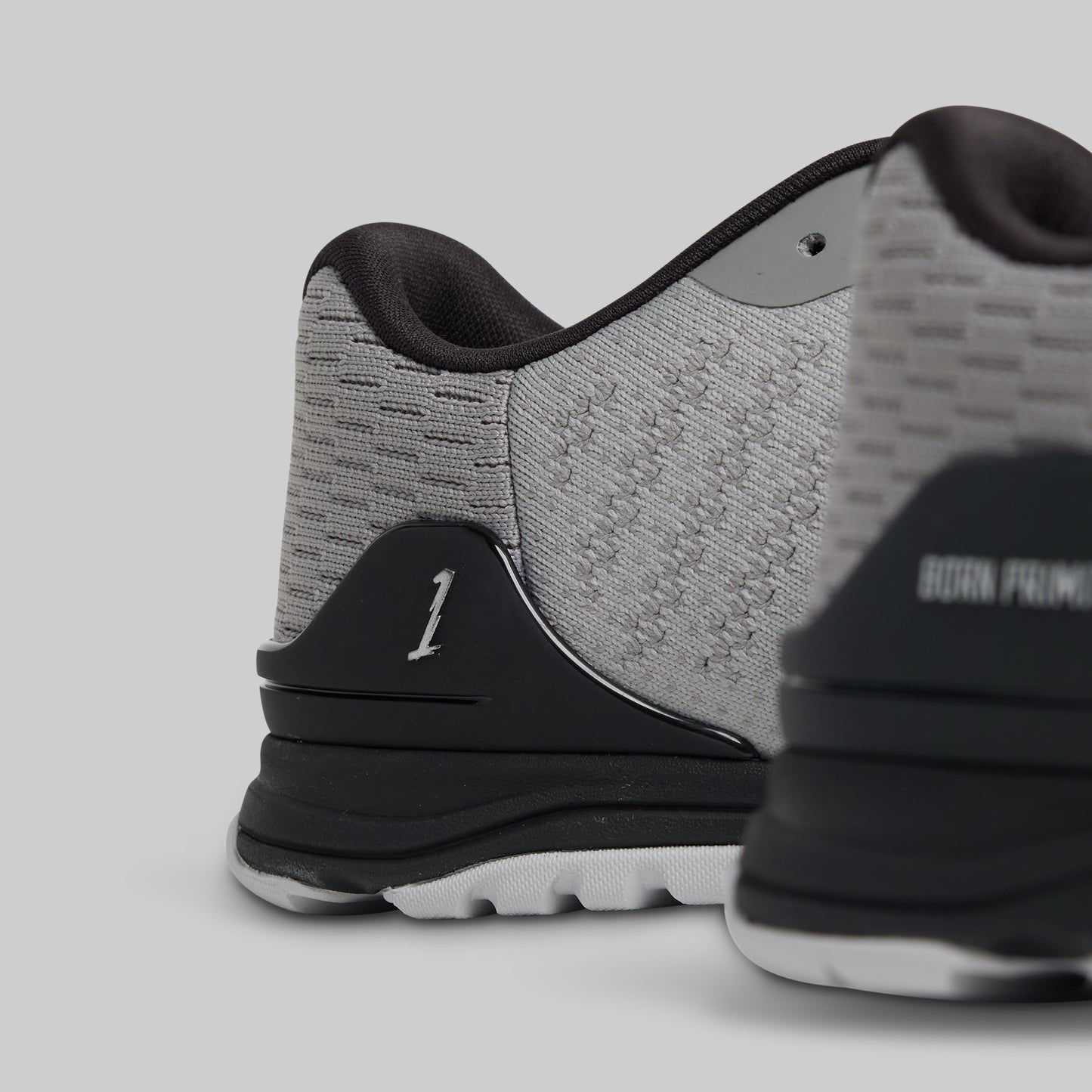 Close-up of a gray and black athletic shoe on a light gray background