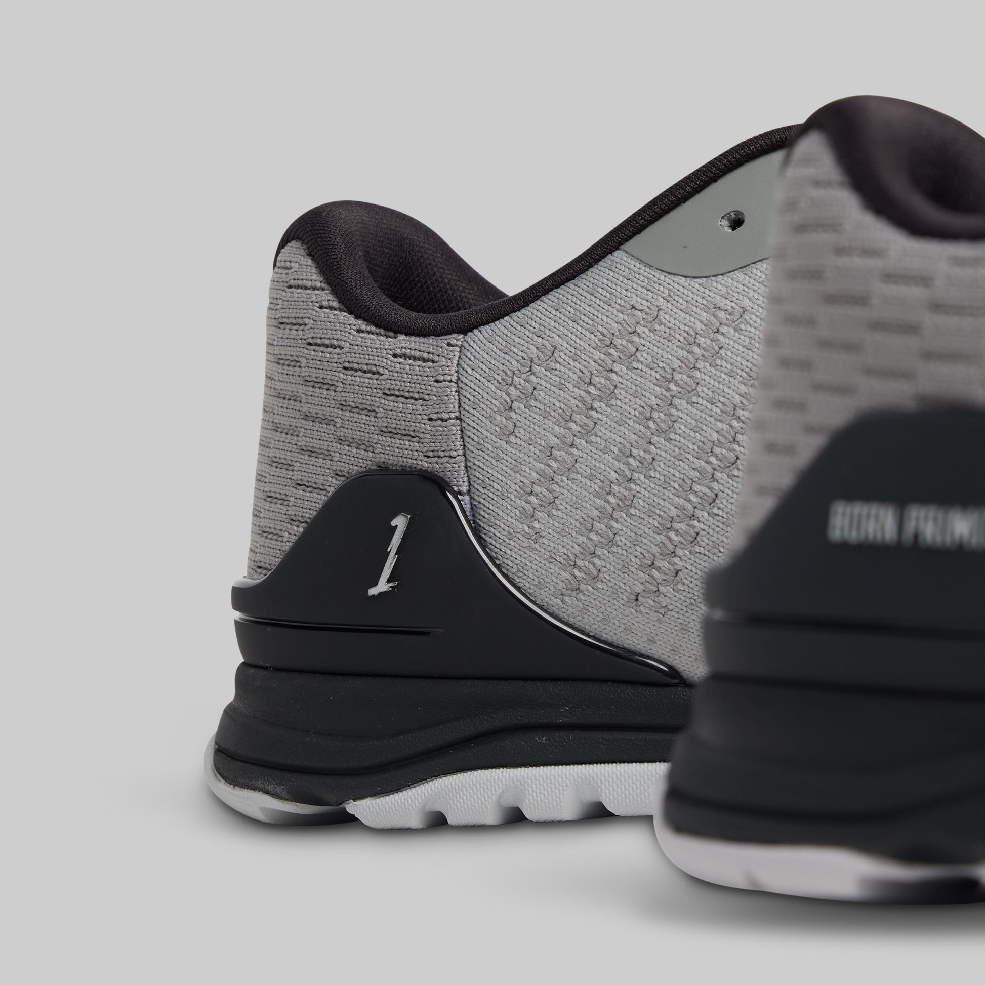 Close-up of a gray and black athletic shoe on a light gray background