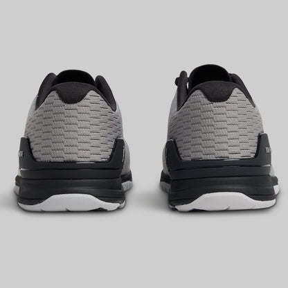 Gray and black athletic shoes on a light gray background