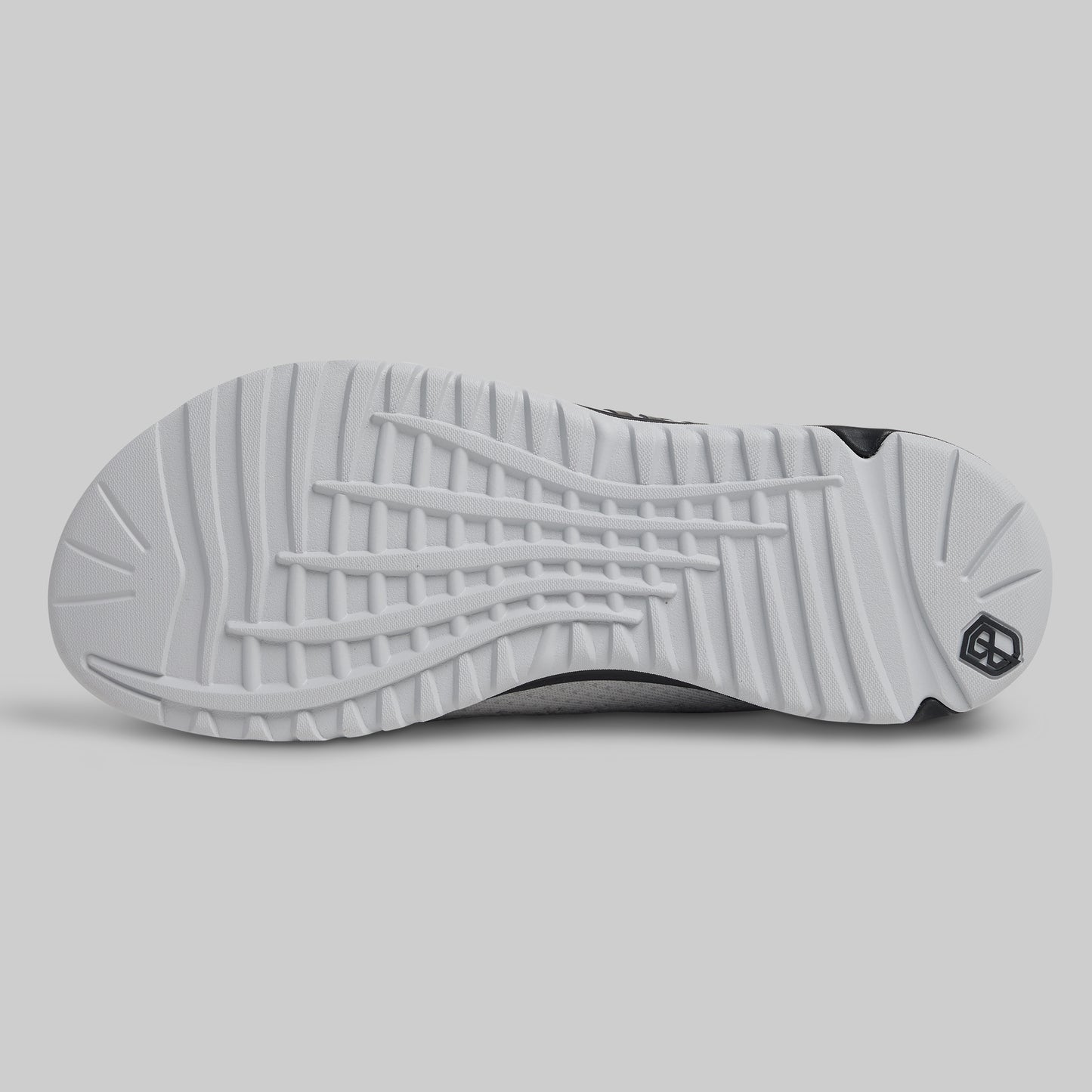 Close-up of a shoe sole with tread pattern on a gray background
