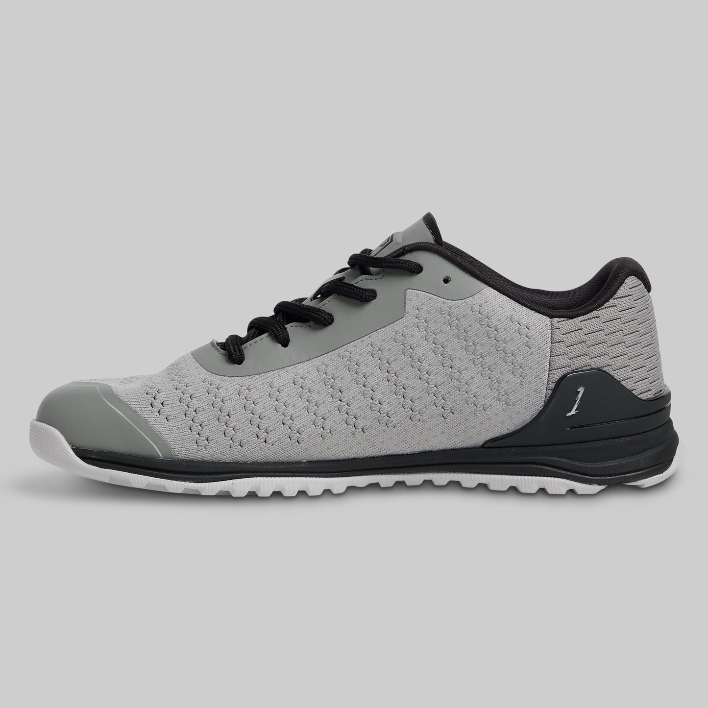 Gray athletic shoe with black accents on a light gray background