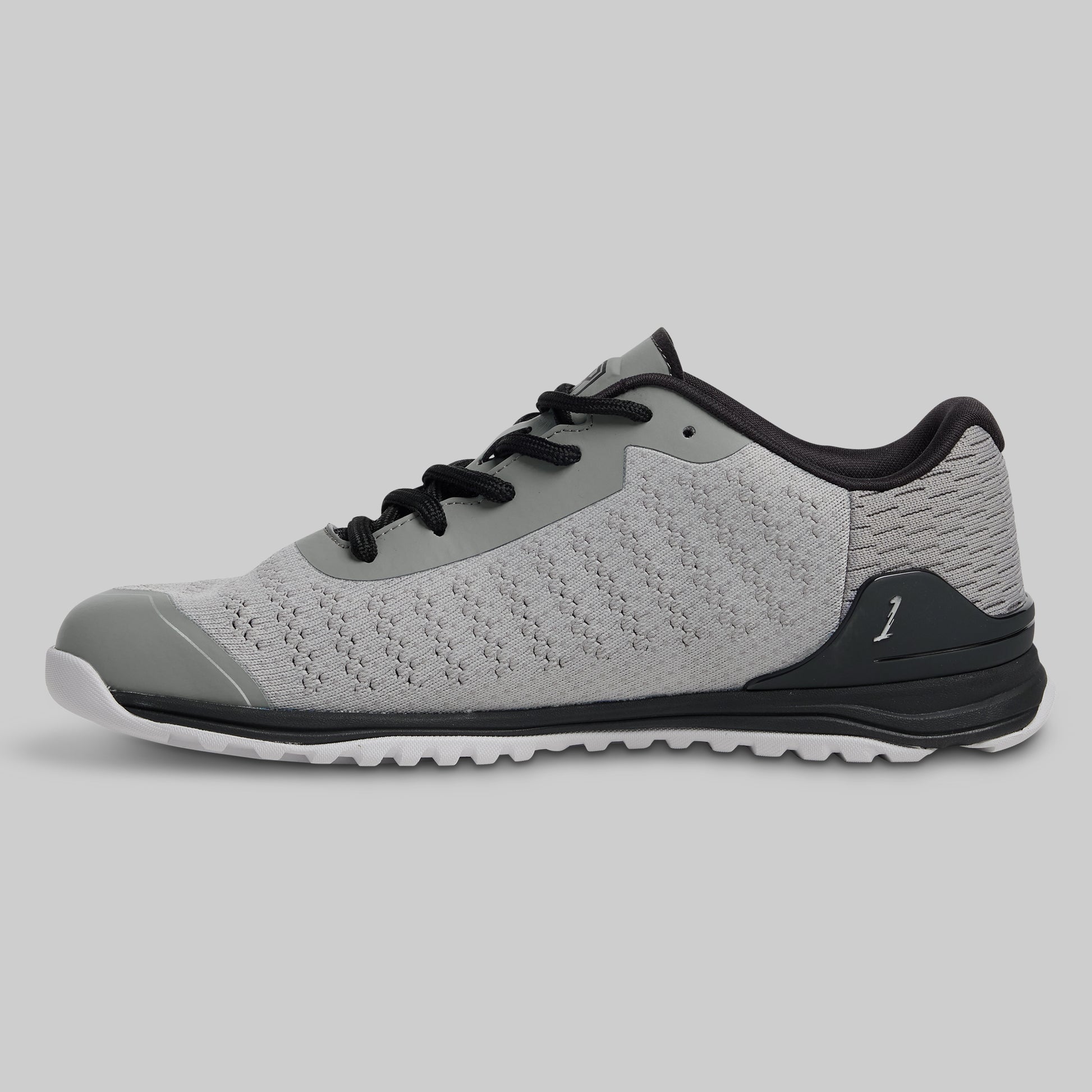 Gray athletic shoe with black accents on a light gray background