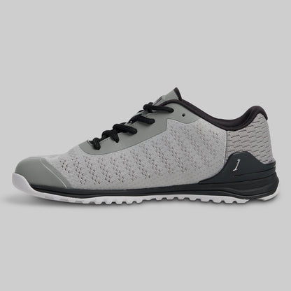 Gray athletic shoe with black accents on a light gray background