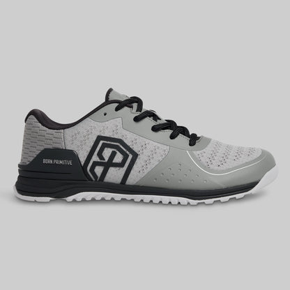 Gray athletic shoe with black accents on a light gray background