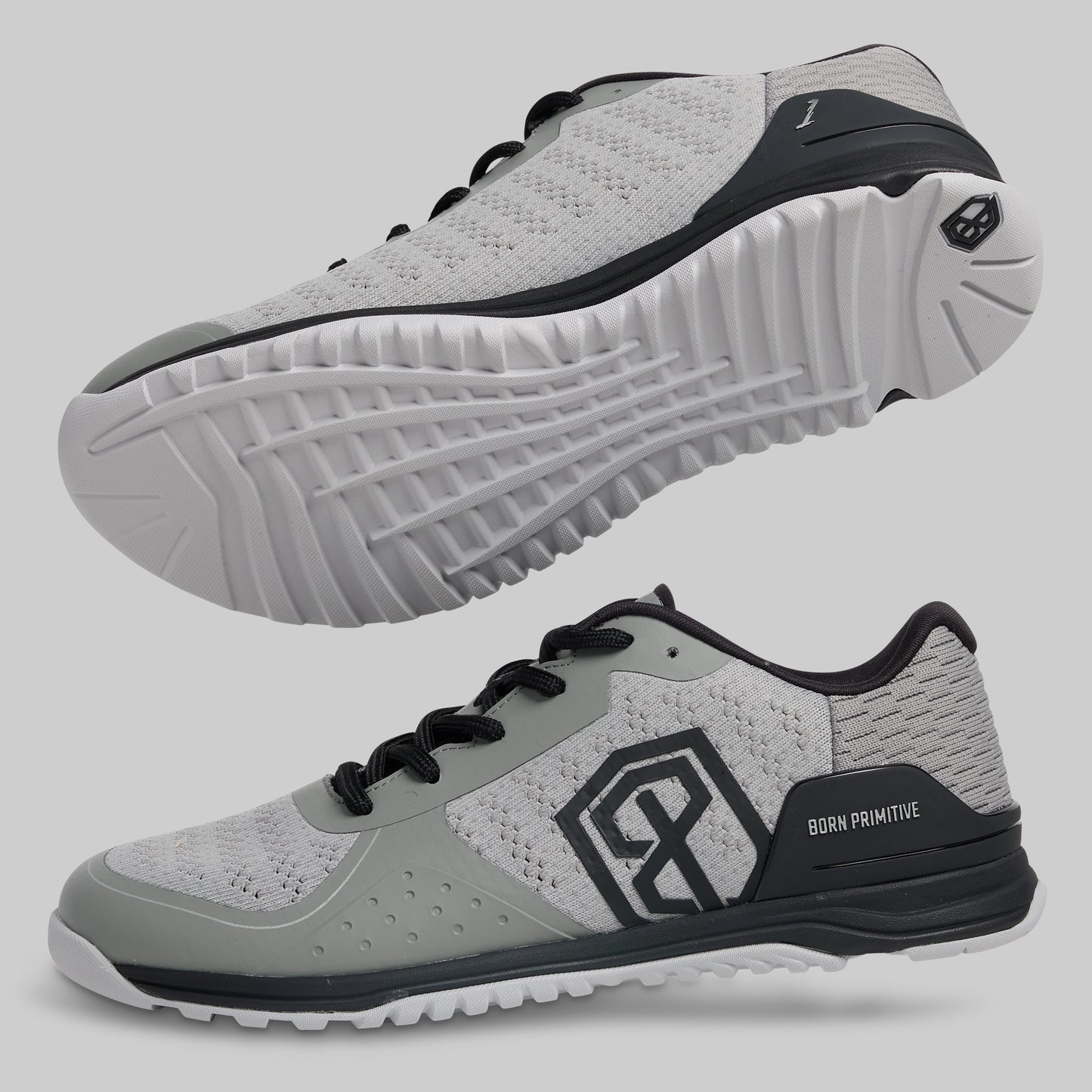 Gray athletic shoes with black accents on a light gray background