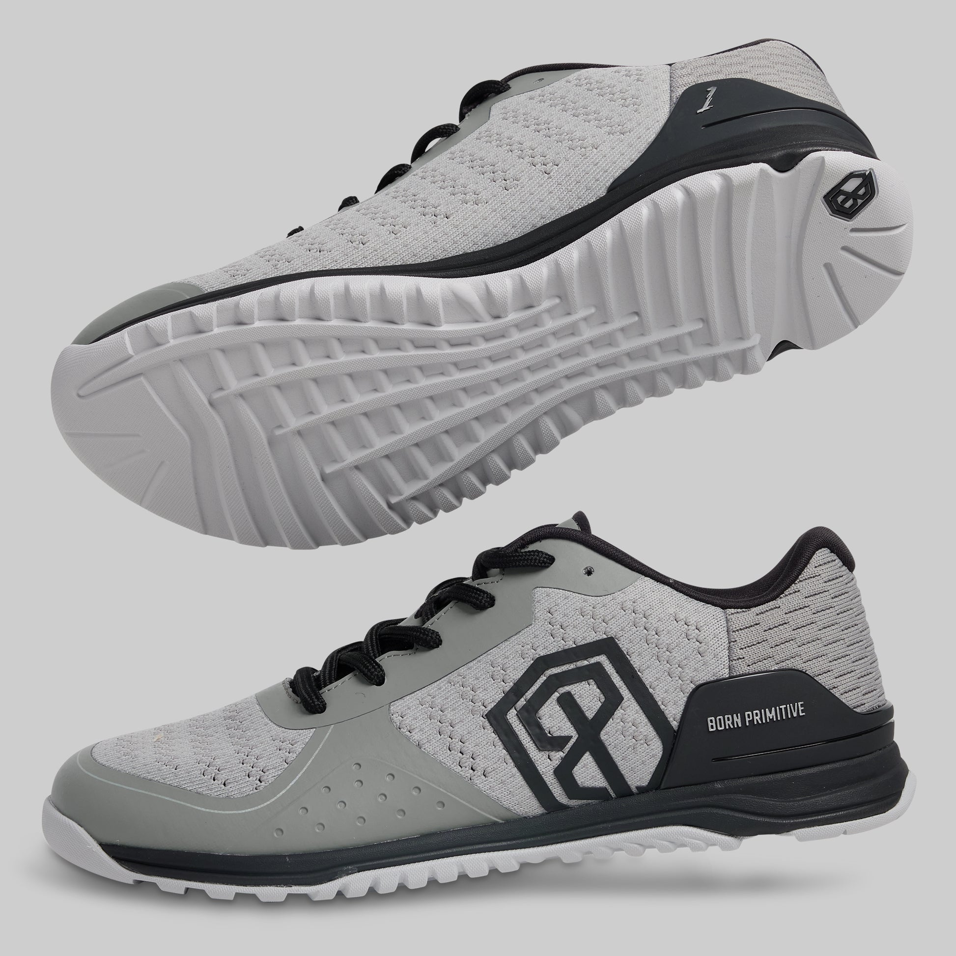 Gray athletic shoes with black accents on a light gray background