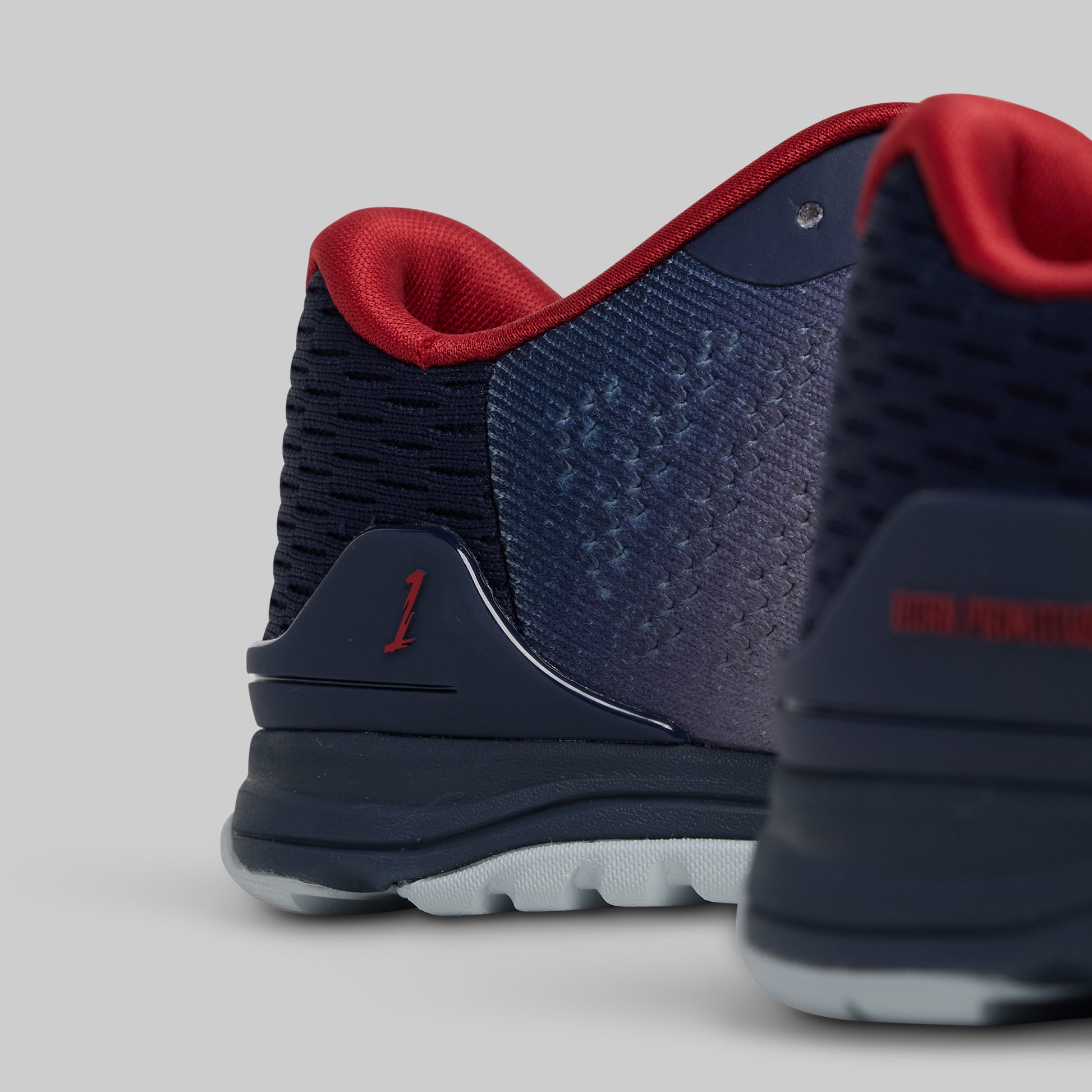 Navy and red athletic shoes on a light gray background