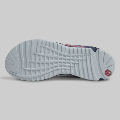 Close-up of a sneaker sole with tread pattern on a gray background