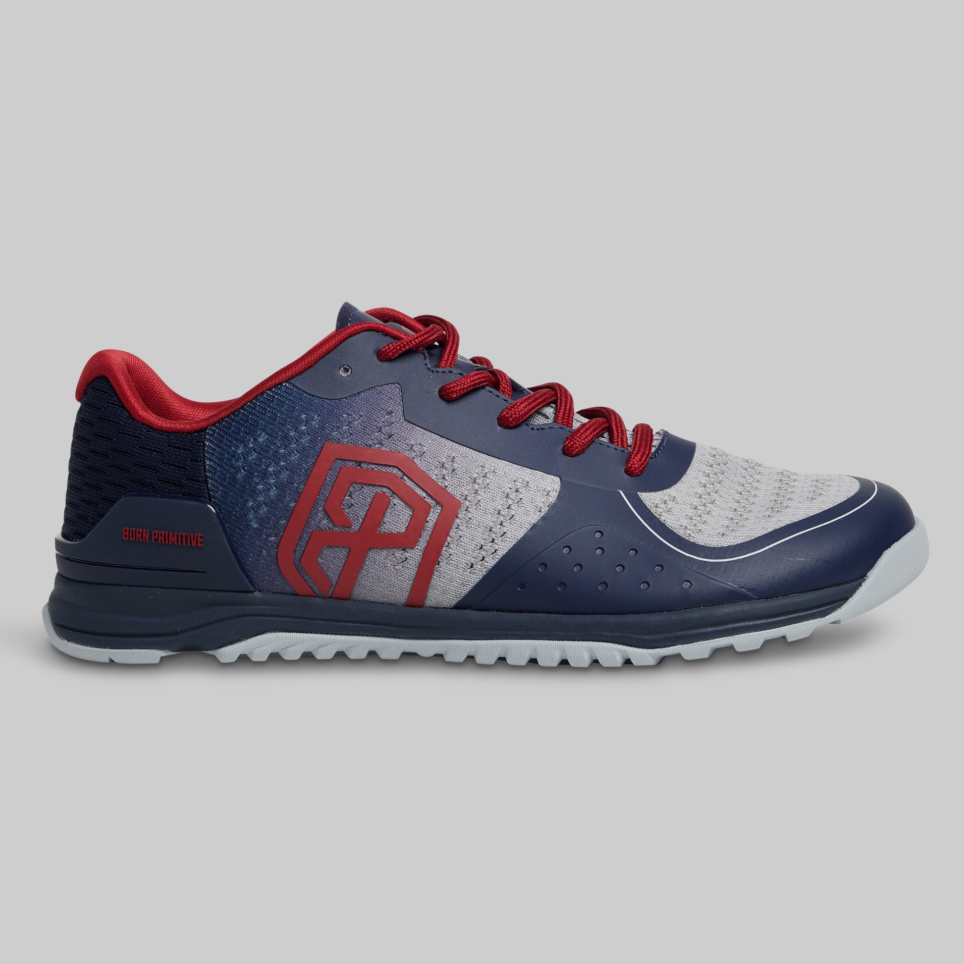 Navy and red athletic shoe on a gray background