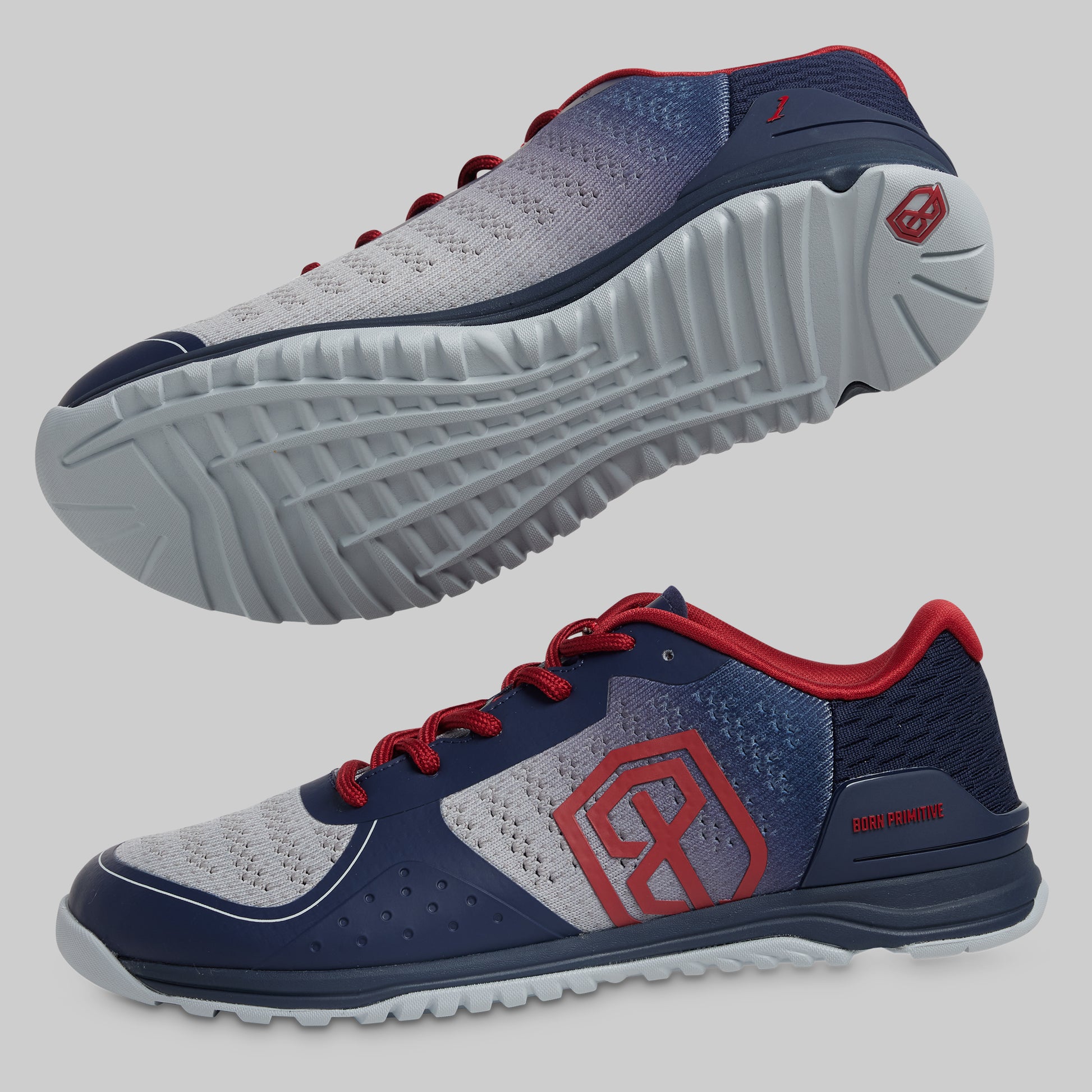 Navy and gray athletic shoes with red accents on a light gray background