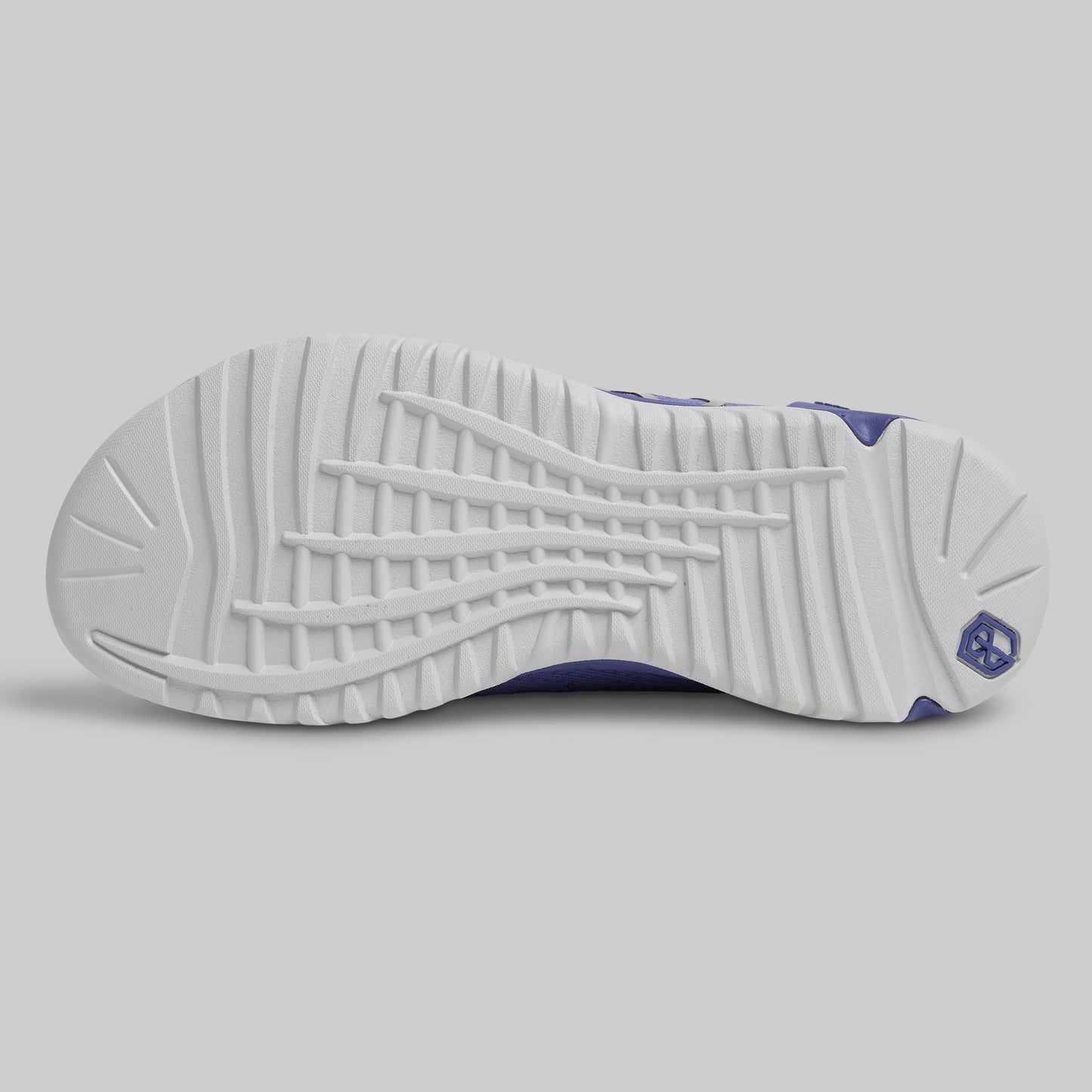 Close-up of a white sneaker sole with purple accents on a light gray background