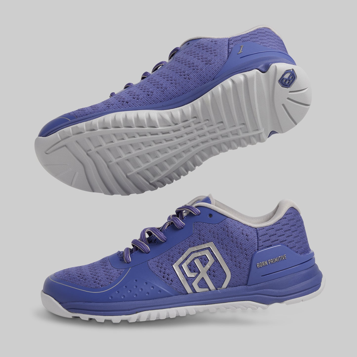 Blue athletic shoes with white soles on a gray background