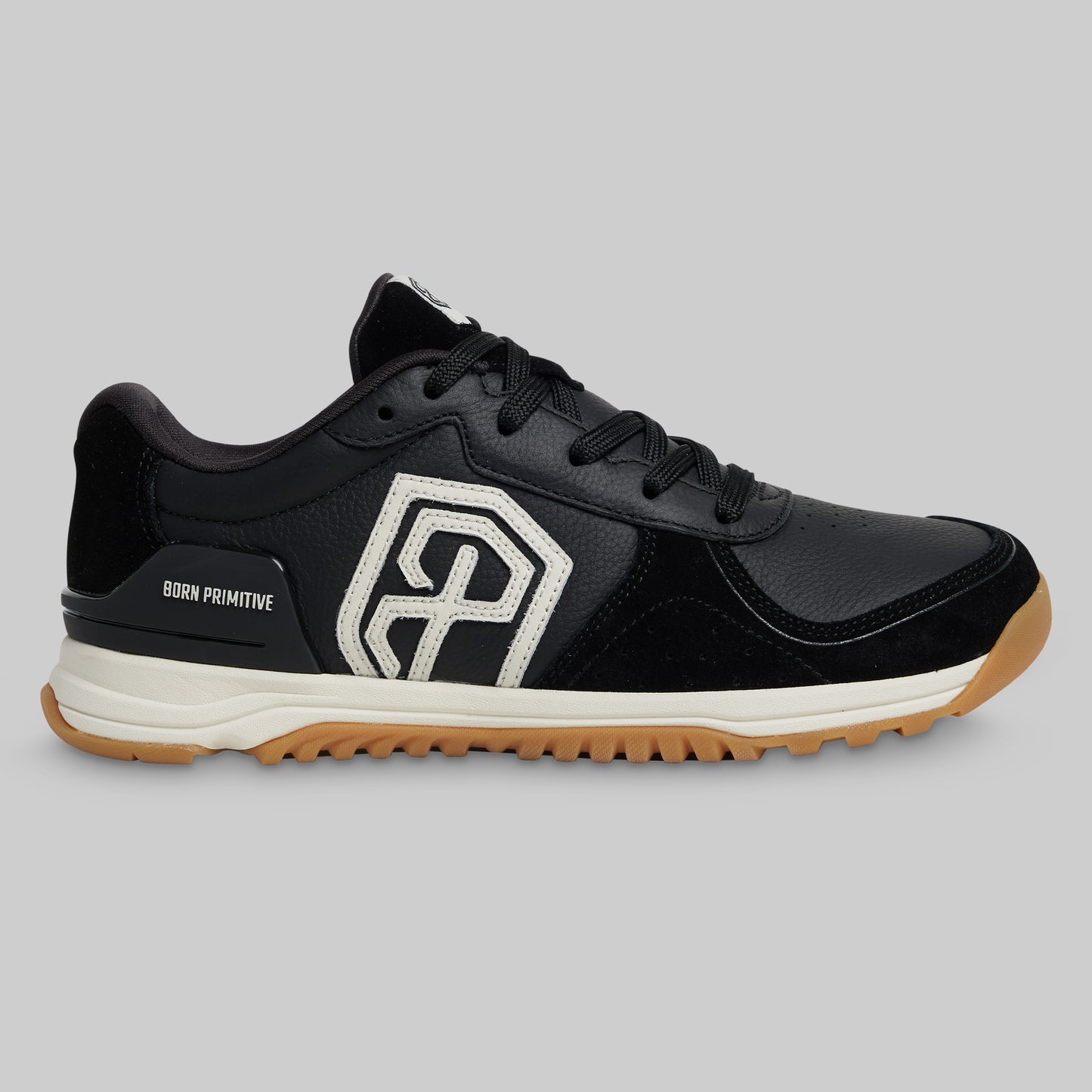 Black athletic shoe with a distinctive logo on a gray background