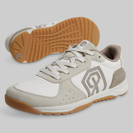 Gray and white sneakers with brown soles on a light gray background