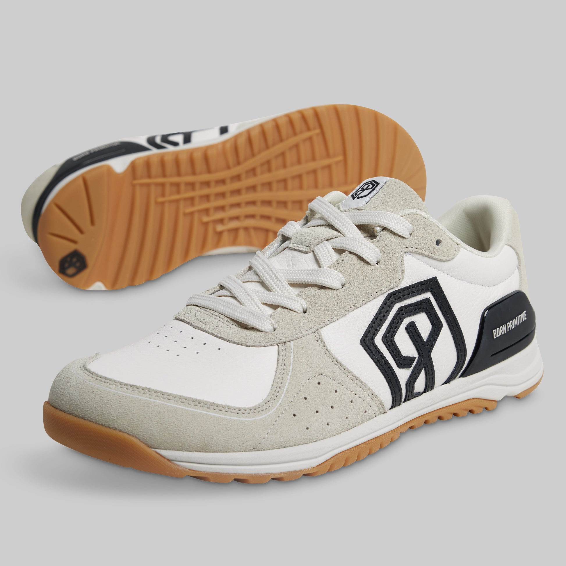 White and beige sneaker with brown sole on a light gray background