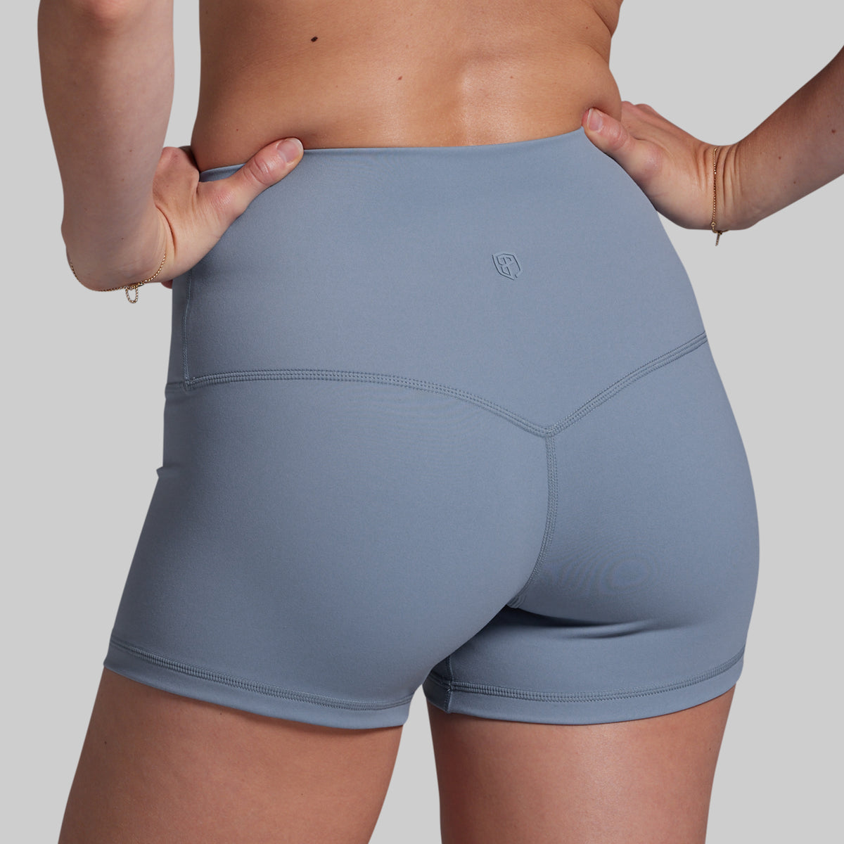 Gray athletic shorts worn by a person on a plain background