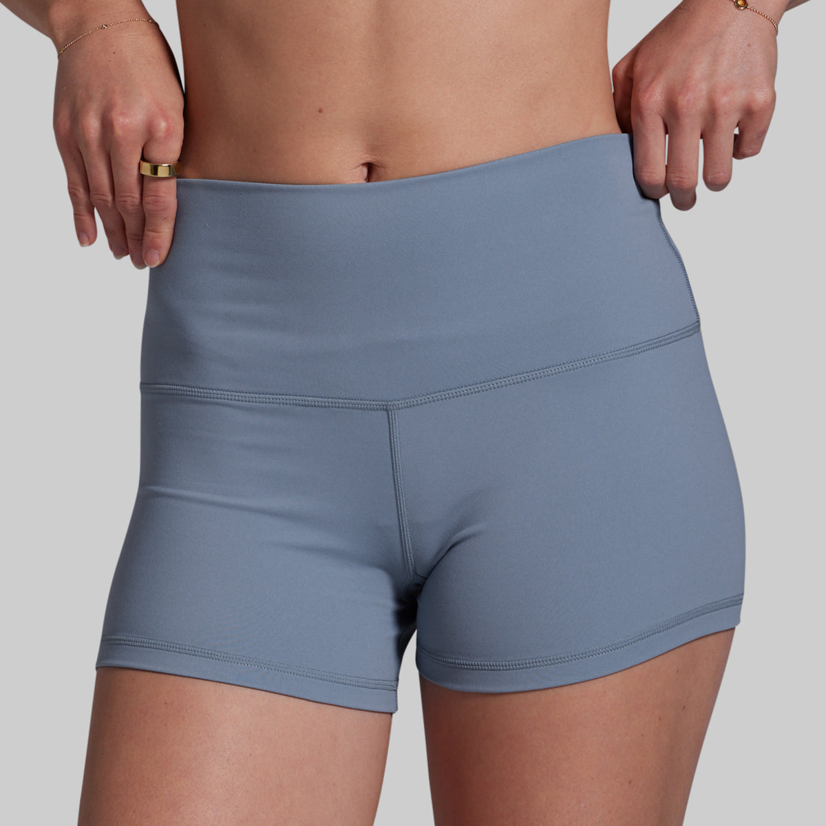 Blue athletic shorts worn by a person on a plain background