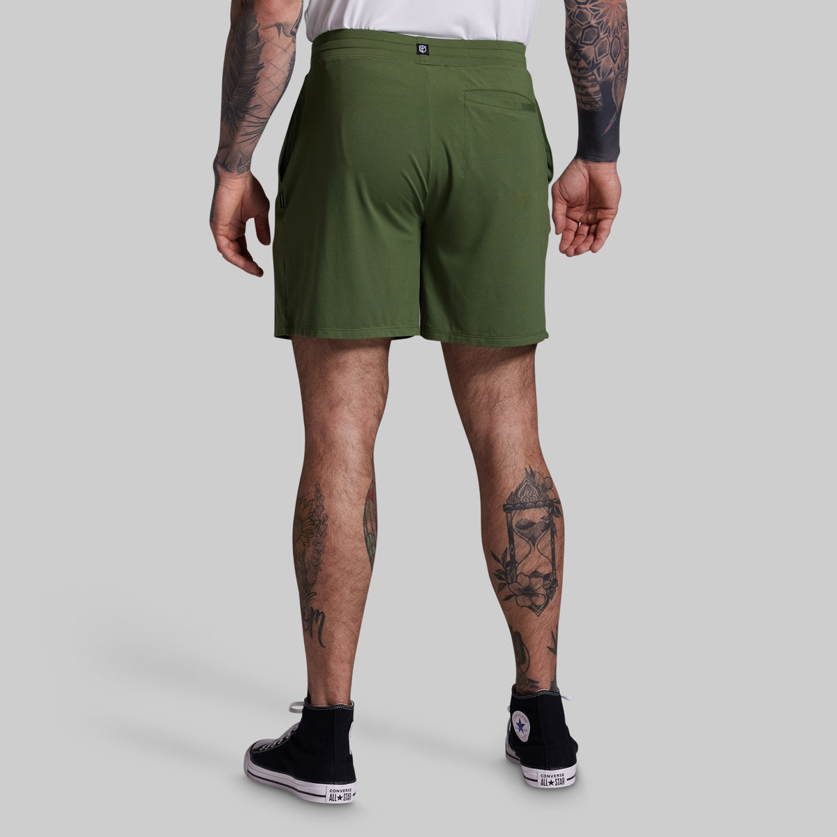 Person wearing green shorts on a plain background