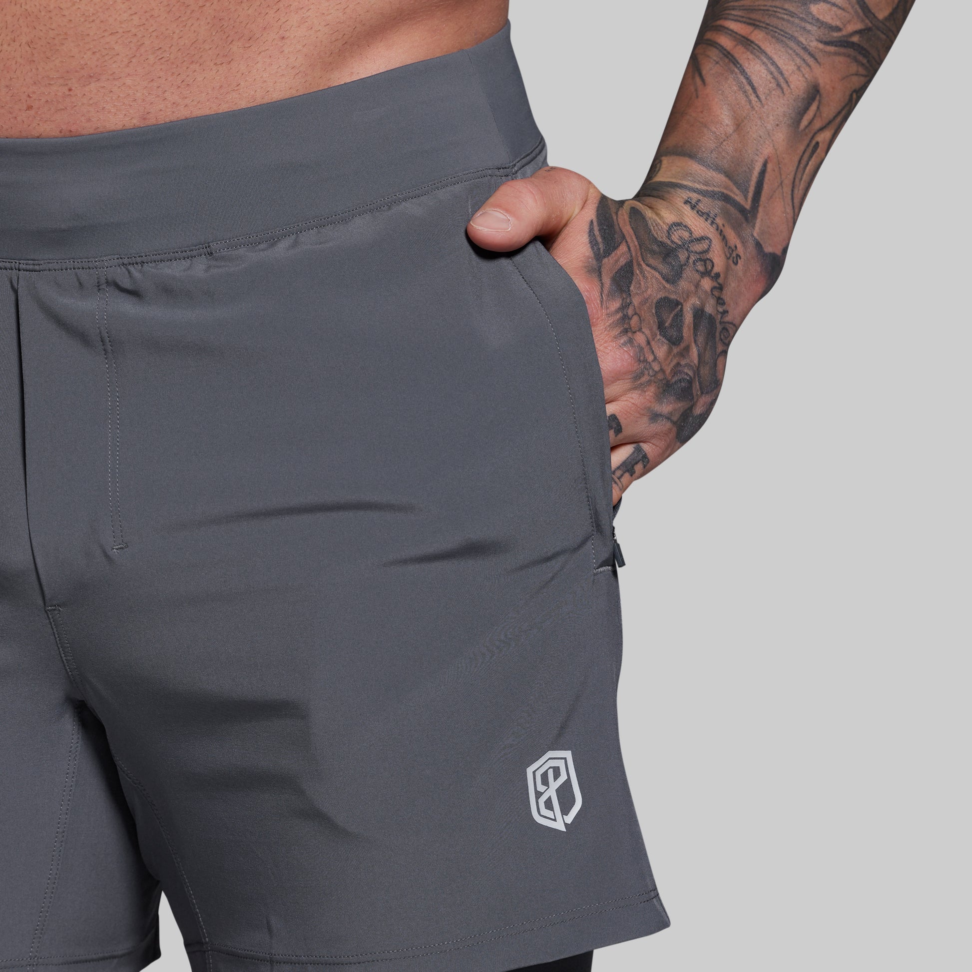 Gray shorts with a brand logo on a gray background