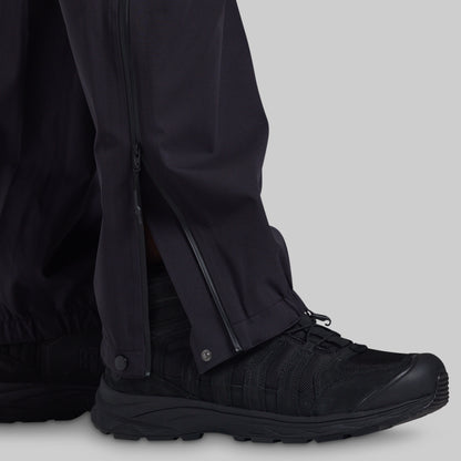 Full-length side zipper open over a boot on black Mission FLEX Rain Pant 2.0
