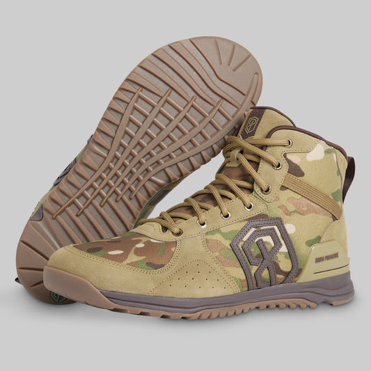 A pair of tactical high-top boots in a tan and brown camouflage pattern, with one boot showing the textured outsole and the other showing the side profile with a gray logo.