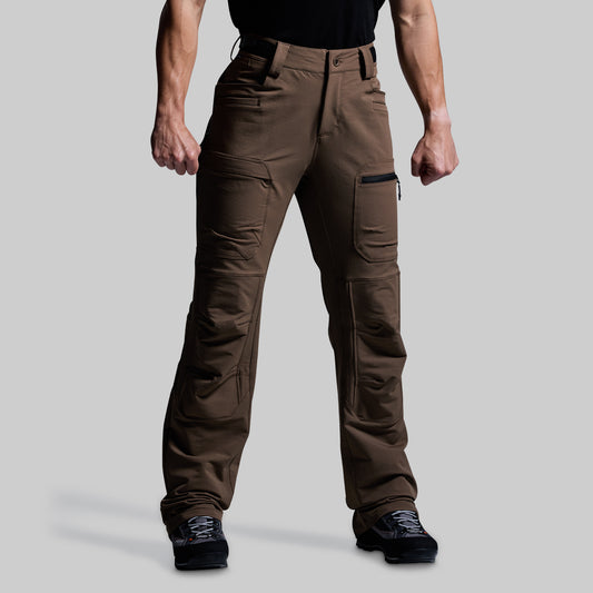 Brown outdoor pants worn by a person on a gray background