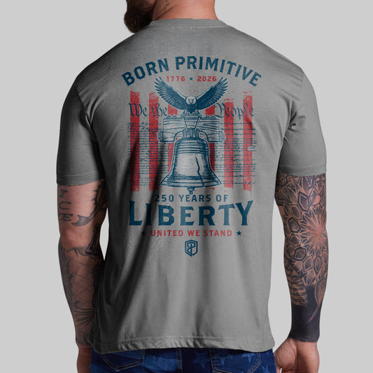 Gray t-shirt with 'Born Primitive' design featuring an eagle and Liberty Bell on a plain background