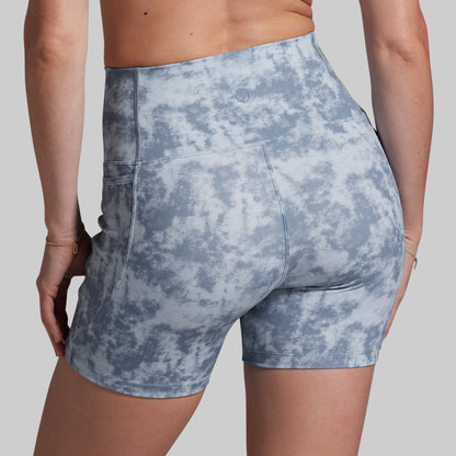 Blue patterned shorts worn by a person on a plain background