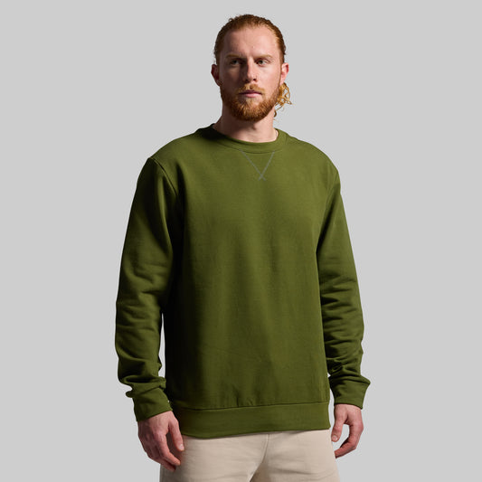 Man wearing a green sweatshirt against a plain background