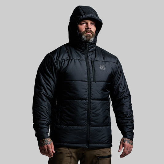 Man wearing a black puffer jacket on a gray background