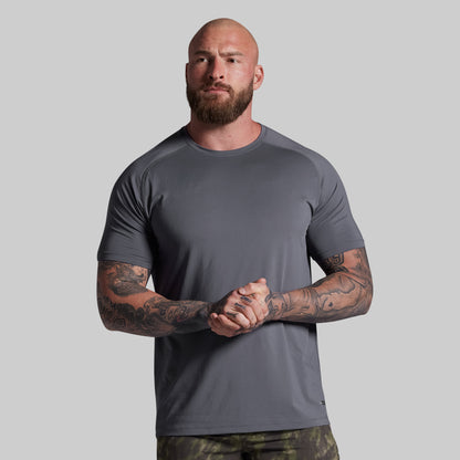 Man wearing a gray t-shirt against a plain background
