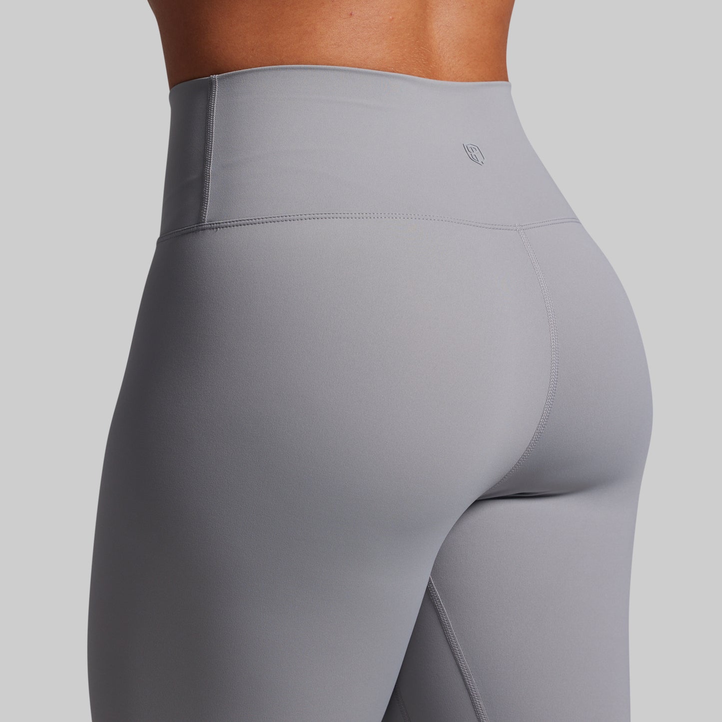 Gray leggings worn by a person on a light gray background