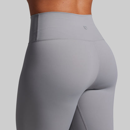 Gray leggings worn by a person on a light gray background
