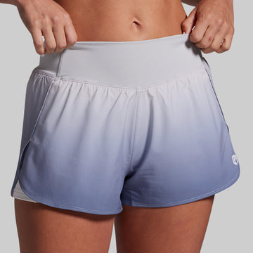 Gradient athletic shorts being worn on a plain background