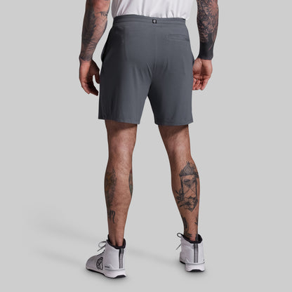 Person wearing gray athletic shorts on a plain background