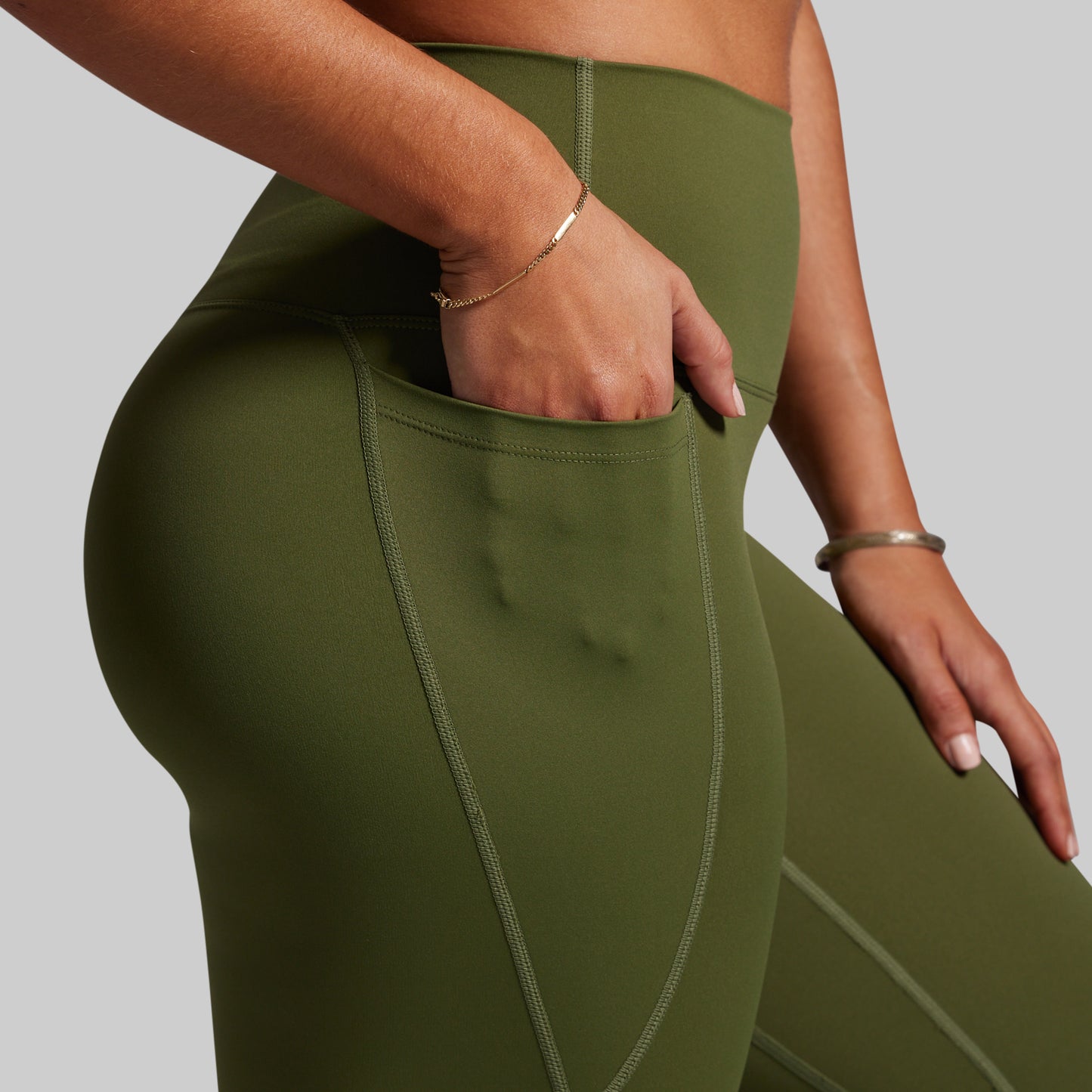 Green leggings worn by a person on a plain background