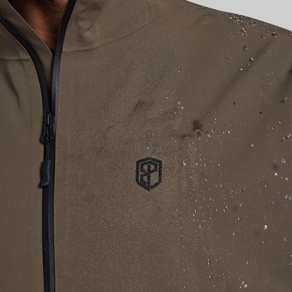Water beading on the chest of the Ranger Green Mission FLEX Rain Jacket 2.0
