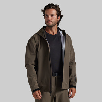 Man wearing the Ranger Green Mission FLEX Rain Jacket 2.0 open over a base layer