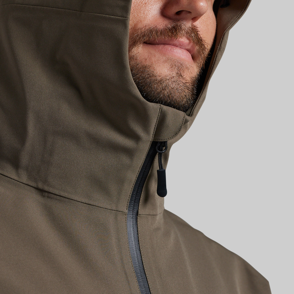 Close-up of the Ranger Green Mission FLEX Rain Jacket 2.0 hood and front zipper